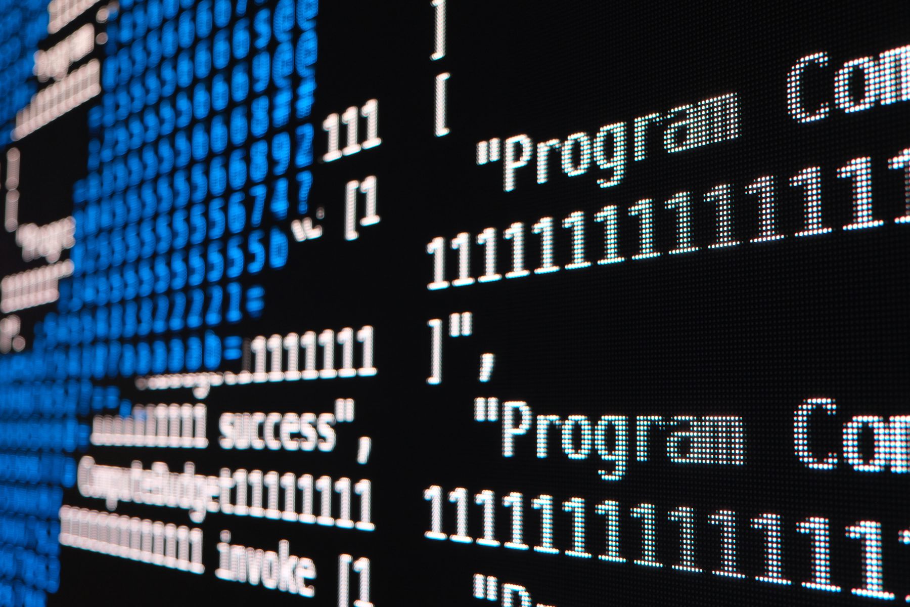 Close-up of an LED wall showing live blockchain transaction strings rendered as blue ASCII characters