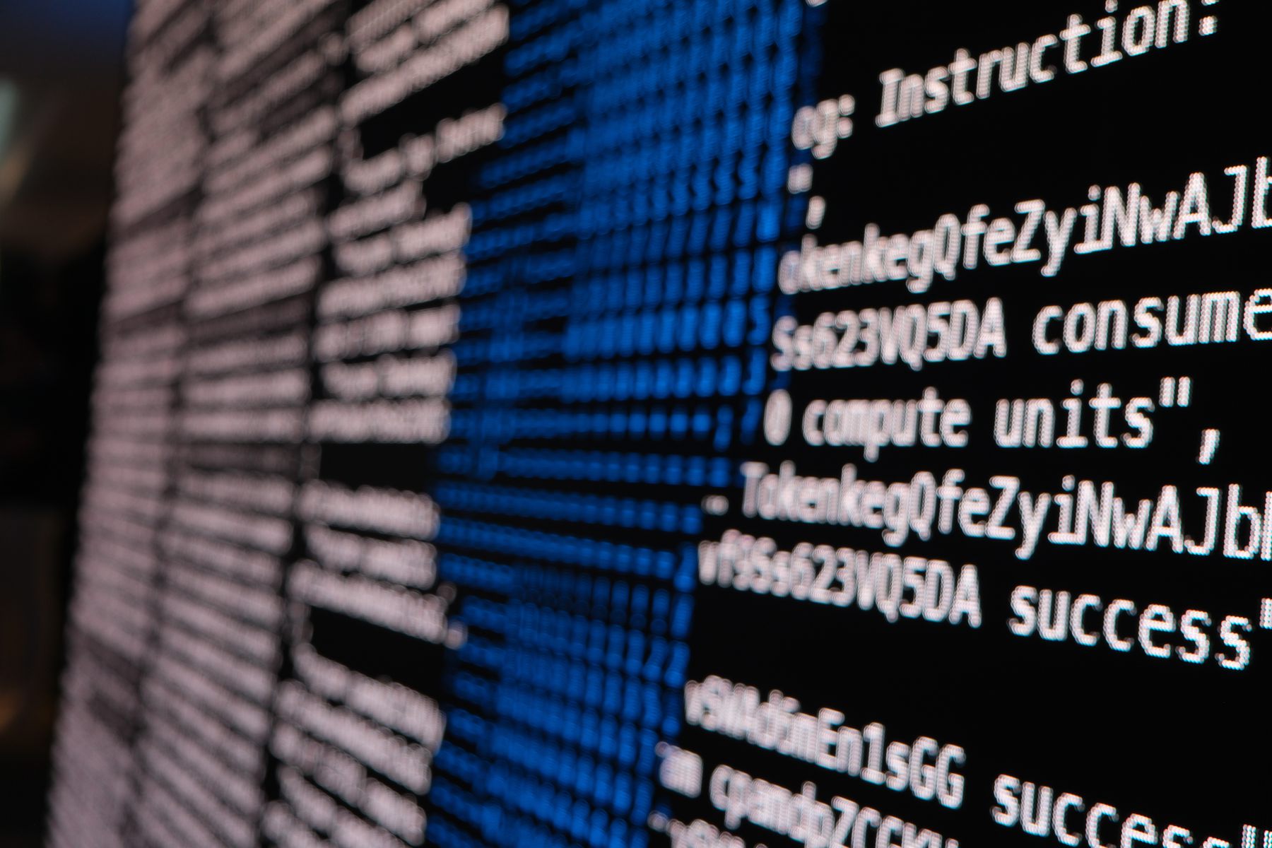 Detail of the wall showing readable Solana program instructions and transaction results as ASCII text