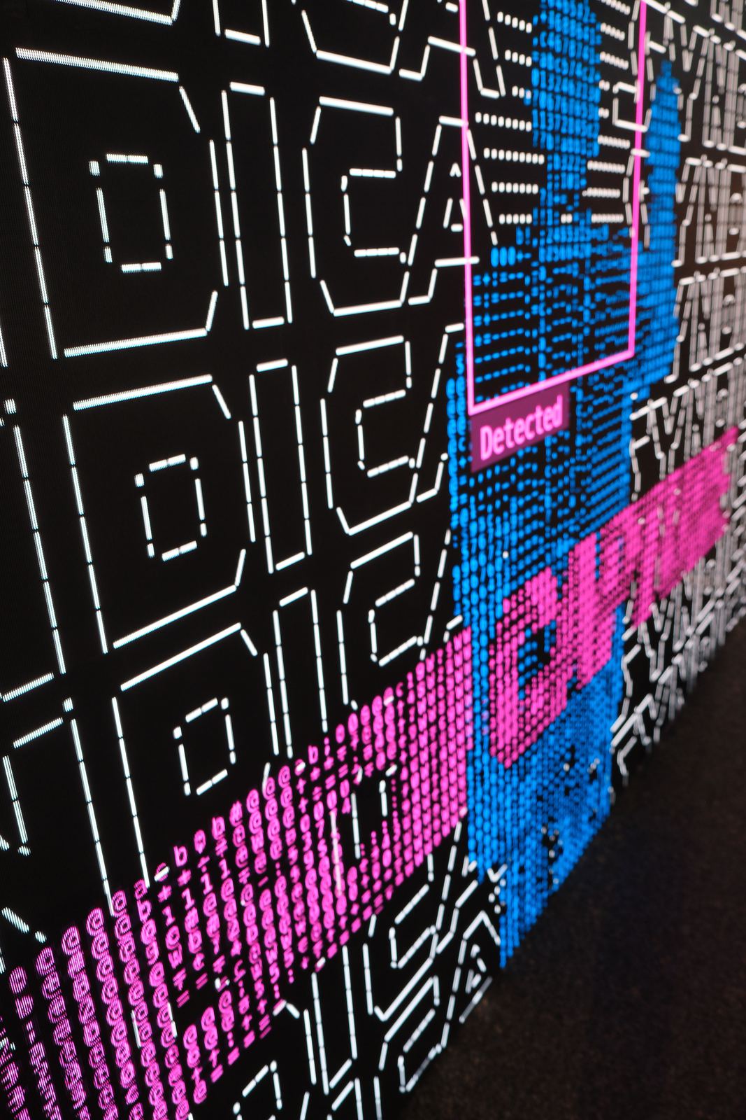 The wall in a magenta and blue graphic state built from ASCII characters