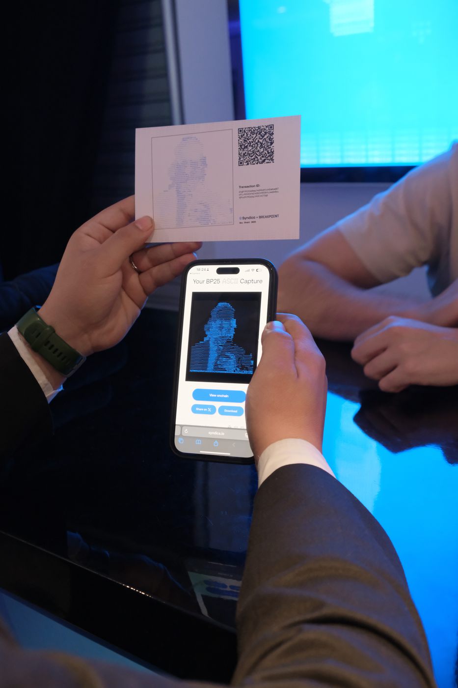 A printed card being scanned with a phone to retrieve the captured image